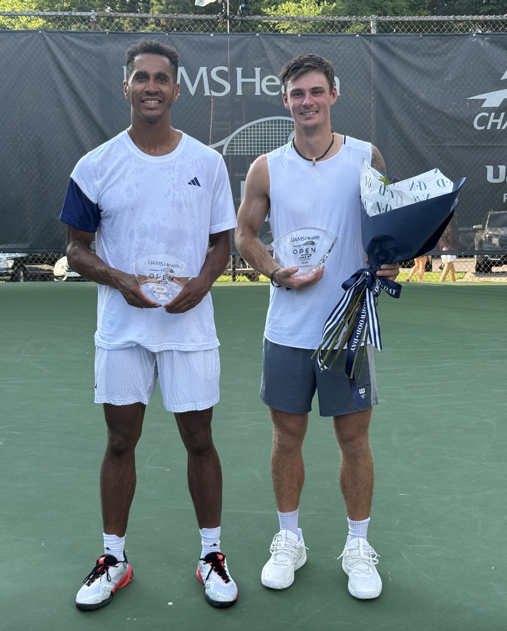 Singles finalist Michael Mmoh, left, and singles champion Colton Smith, right, following the singles championship match at the UAMS Health Little Rock Open